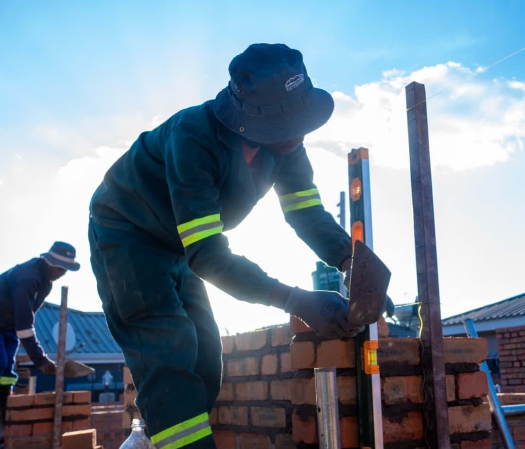Mightlogic bricklayer at work in low afternoon light