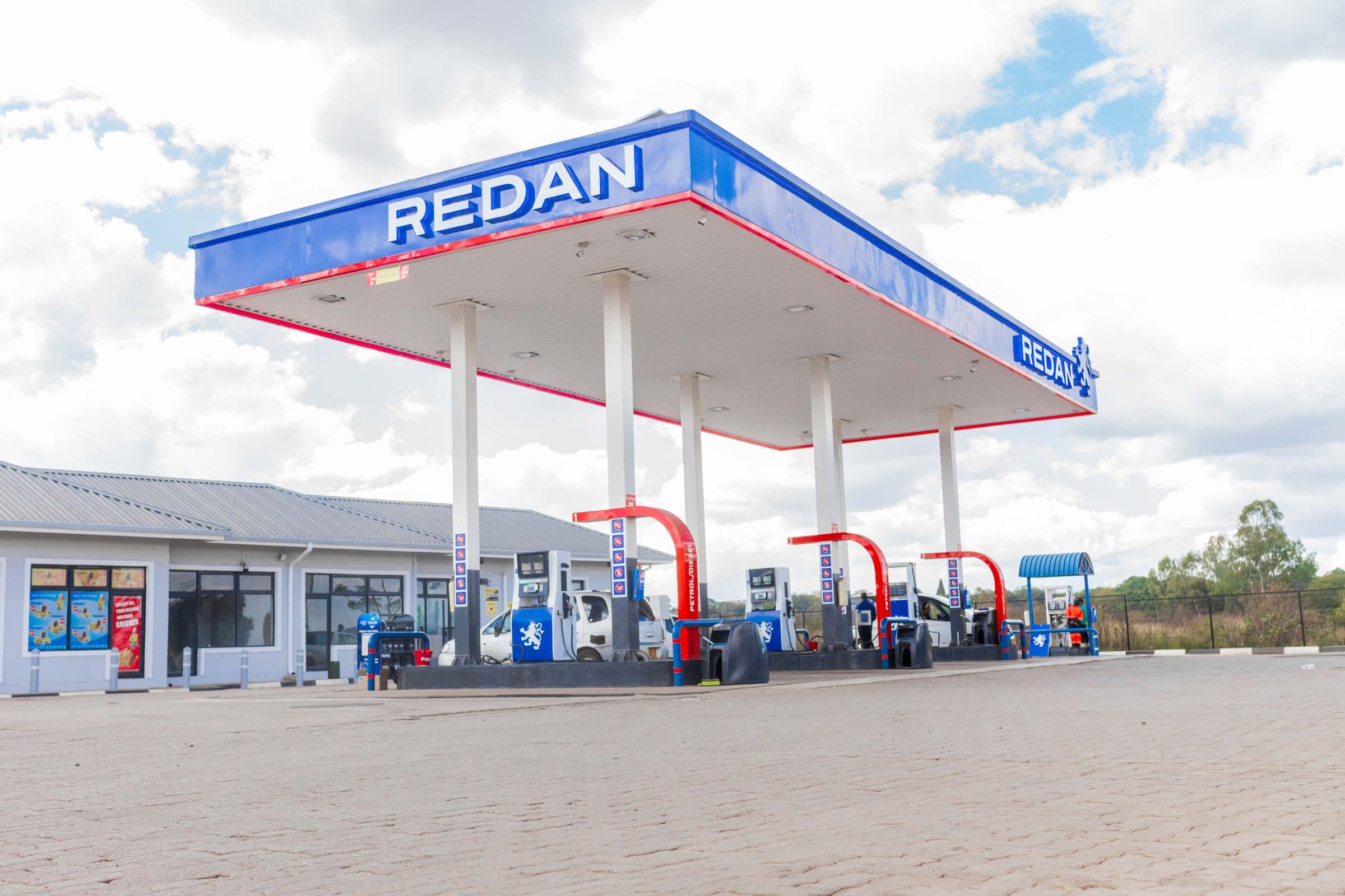 Repainted Redan canopy in brand blue and red, low angle against a bright sky